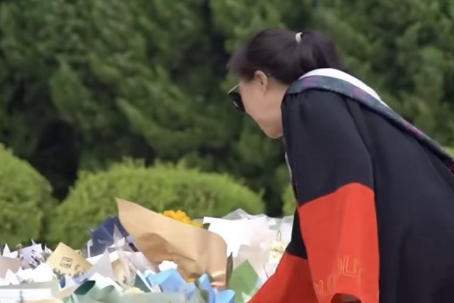 又是一年毕业季，在大连理工大学主楼前，毕业生拍完毕业照后，自发将鲜花留在他的脚下